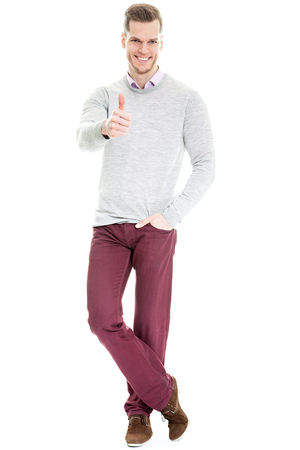 young man showing thumb up isolated on white backgroundの写真素材