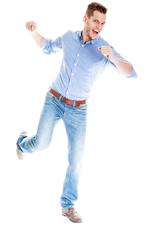 Angry young man smashing something - isolated on white backgroundの写真素材