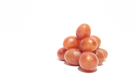 Red Grapes Stacked Into a Pyramid on White Background.  Grape Bunch/Collection.の写真素材