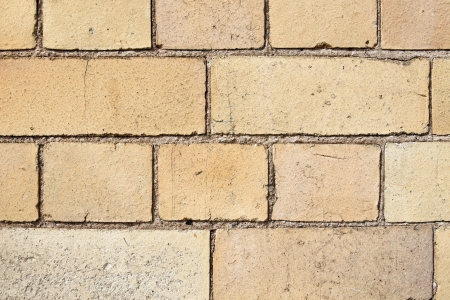 Background texture of old yellow colored Victorian bricks and mortarの写真素材