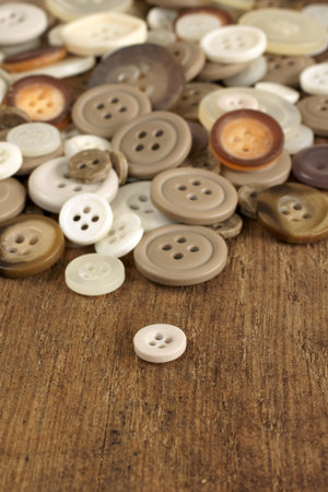 Stack of old fashioned brown beige and white buttons