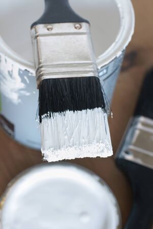 Painting and decorating a pot of white paint and brushの写真素材