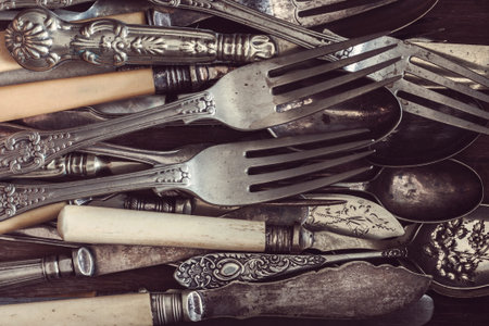 Vintage knives forks and spoons with a vintage style filter applied to image