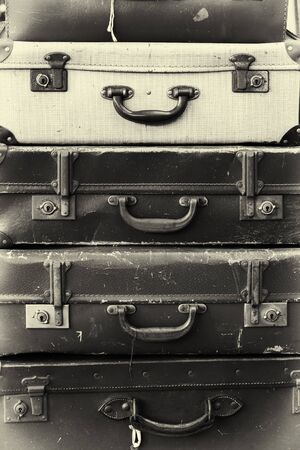 Stack of old battered suitcases with vintage style filterの写真素材