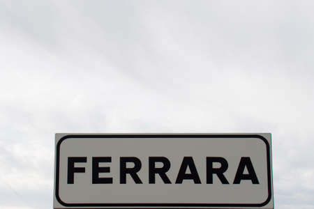 road sign with the name of the city ferraraの写真素材