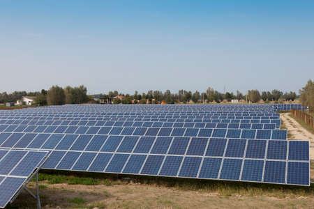 modern solar panels in a beautiful green fieldの写真素材
