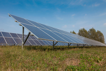 modern solar panels in a beautiful green field