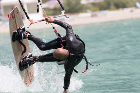 LAKE OF SANTA CROCE, ITALY - JULY 12: Professional kite-surfer demonstrating his ability 2014, July 12, 2014 in Lake of Santa Croce, Alpago, belluno, Italyのeditorial素材