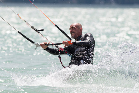 LAKE OF SANTA CROCE, ITALY - JULY 12: Professional kite-surfer demonstrating his ability 2014, July...
