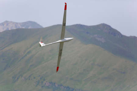 VAL DI FASSA â COL DEL CUC, ITALY - JULY 28: Radio controlled model airplane in flight in a Euromeeting Fly, July 28, 2013 in Val Di Fassa, Pordoi, Col del Cuc, Italyのeditorial素材