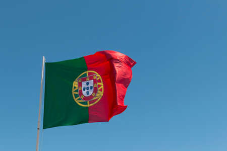 Portuguese flag over a clear blue skyの写真素材
