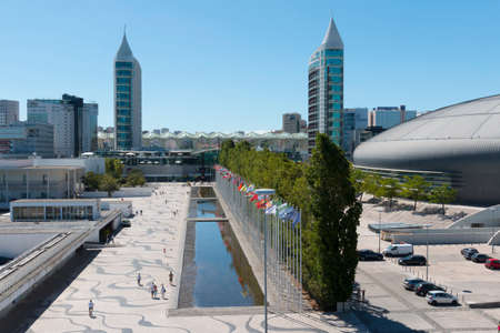 Lisbon, Portugal - August 07, 2014: Visitors comming in and out of the Vasco da Gama Shopping, Sao Rafael Tower in the back and Homem-Sol (Sun-Man) Sculpture. Parque das Nacoes.のeditorial素材