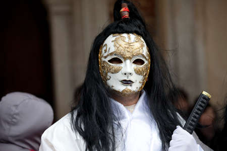 Venice, Italy â February 11, 2012: People posing wearing a typical Carnival mask in St. Mark's Squareのeditorial素材