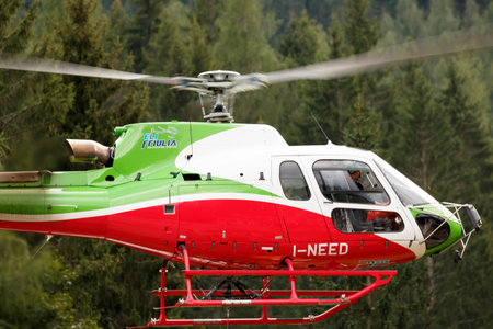 Falcade, Belluno, Italy - August 21, 2015: transport helicopter provides material for a construction site in the mountainsのeditorial素材
