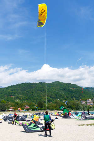 Lake Of Santa Croce, Italy â May 21, 2016: Kitesurfing action at the lake. Preparation, starting from the beach, sailing in the lakeのeditorial素材