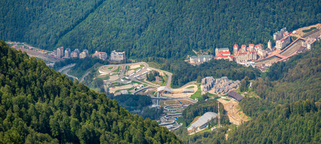 Panoramic view from the top of the Aibga ridge at the ski resort, surrounded by high mountains. Krasnaya Polyana, Sochi, Caucasus, Russia.の写真素材