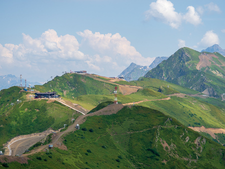Serpentine road to the top of a high mountain range with cable cars. Krasnaya Polyana, Sochi, Russia.の写真素材