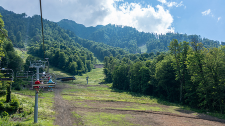 Summer view from the chair of the rope tow on the green slopes of the mountains ith ski tracesの写真素材