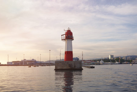 Red and white lighthouse at the entrance to the seaport. Sochi, Russia.の写真素材