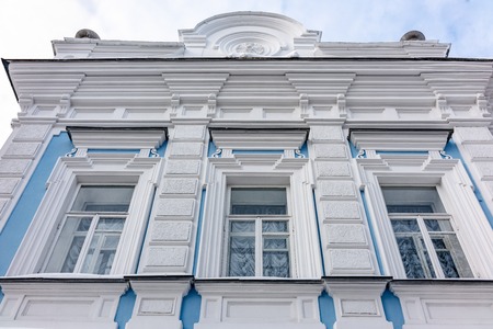 Three windows of the old mansion of the 19th century with blue and white walls with perspective distortion of space.の写真素材