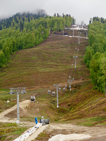Cable car on the spring slope with melted snow. Krasnaya Polyana, Sochi, Russiaの写真素材
