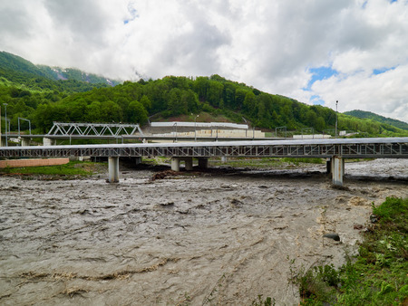 The powerful flow of a mountain river in the spring. Spring floodの写真素材