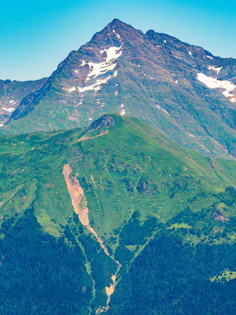 Top view of the mountain range and peaks covered with snow. Mountain peak in the summer.の写真素材