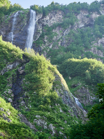 Views of the green mountains with rocks and the highest waterfall.の写真素材