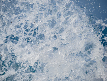 Splashes of water against the sea on a sunny summer day. Copy space backgroundの写真素材