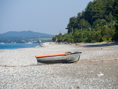Old boat on a deserted sea shore on a sunny summer day. Copy space backgroundの写真素材