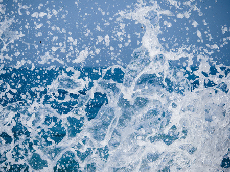 Splashes of water against the sea on a sunny summer day. Copy space backgroundの写真素材