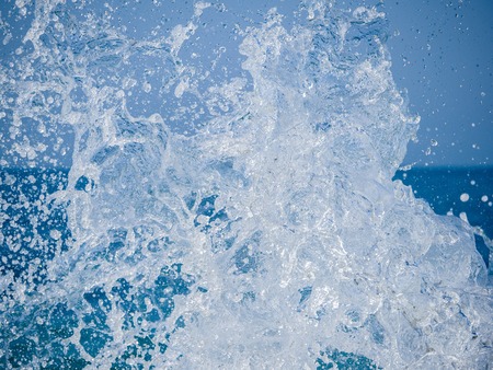 Splashes of water against the sea on a sunny summer day. Copy space backgroundの写真素材