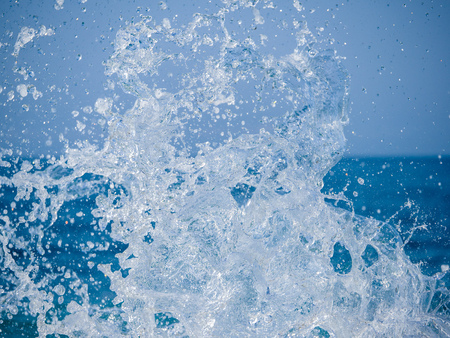 Splashes of water against the sea on a sunny summer day. Copy space backgroundの写真素材