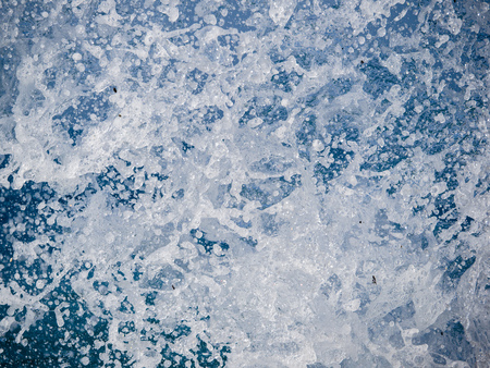 Splashes of water against the sea on a sunny summer day. Copy space backgroundの写真素材