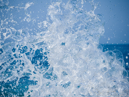 Splashes of water against the sea on a sunny summer day. Copy space backgroundの写真素材