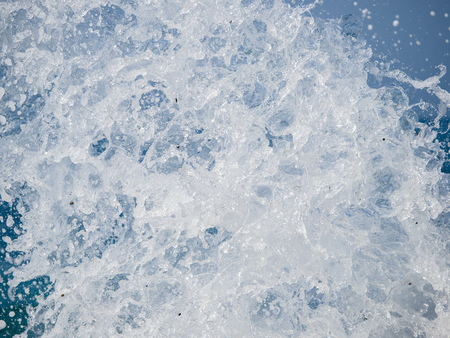 Splashes of water against the sea on a sunny summer day. Copy space backgroundの写真素材