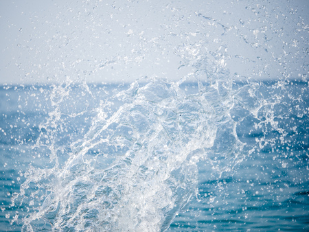 Splashes of water against the sea on a sunny summer day. Copy space backgroundの写真素材