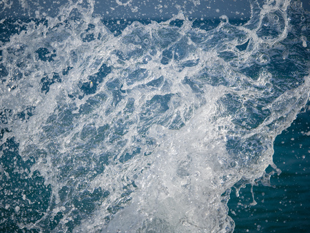 Splashes of water against the sea on a sunny summer day. Copy space backgroundの写真素材