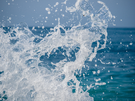 Splashes of water against the sea on a sunny summer day. Copy space backgroundの写真素材