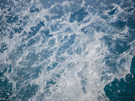 Splashes of water against the sea on a sunny summer day. Copy space backgroundの写真素材