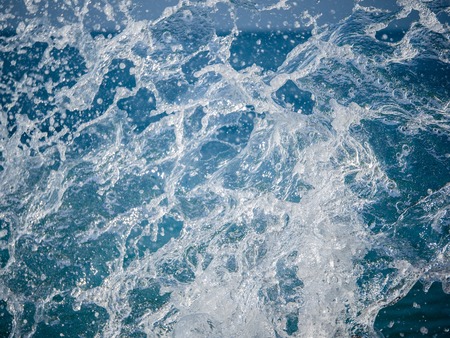Splashes of water against the sea on a sunny summer day. Copy space backgroundの写真素材
