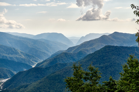 The gorge among the mountains with green slopes. Krasnaya Polyana, Sochi, Russiaの写真素材