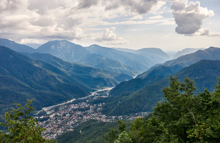 Village in a mountain valley among the green forest. Krasnaya Polyana, Sochi, Russiaの写真素材