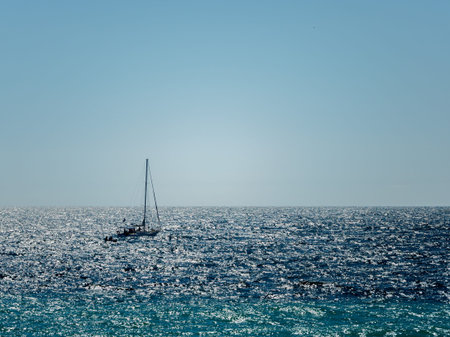 Sailing boat in bright shiny sea water. Blue sea on a sunny day.の写真素材