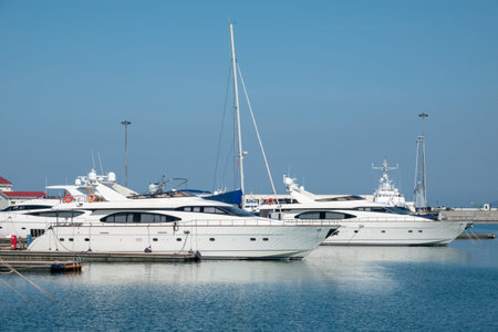 Expensive 92 foot yacht at the pier. Beautiful clear day in the sea harbor with moored yachts.の写真素材