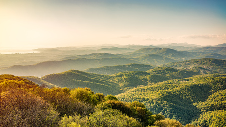 Layers of green mountains and hills in the haze during sunset. View from Mount Akhun, Sochi, Russia.の写真素材