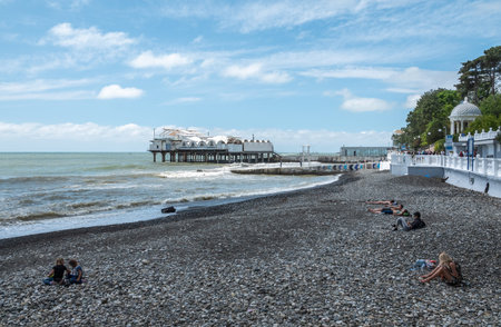 Sochi - Russian Feseration - May 09, 2019 - Seafront and beach during a storm. Platform on supports in the sea near the shore.のeditorial素材
