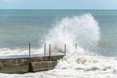 Sea wave with spray during storm at Black sea in Sochi, Russia. Muddy sea waves with foam and spray.の写真素材