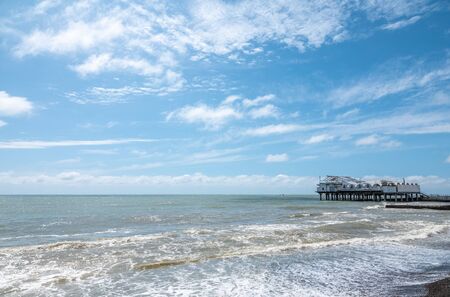 Platform on supports in the sea near the shore. Low dense clouds over the sea.の写真素材