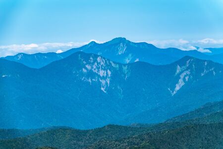 Layers of green mountains and hills in the haze and fog. Krasnaya Polyana, Sochi, Caucasus, Russia.の写真素材